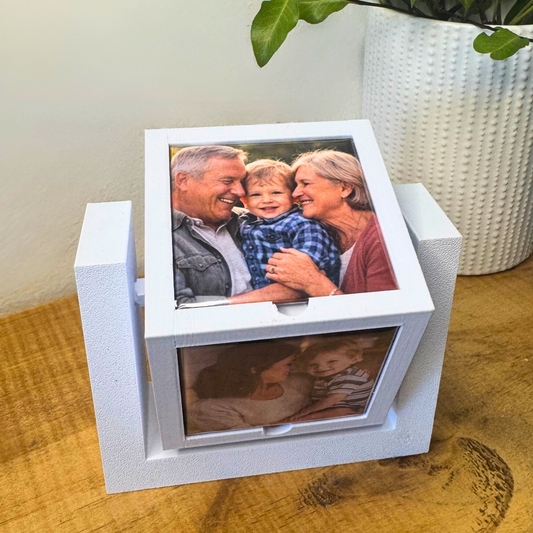 Modern magnet photo display cube on desk with family photo magnets