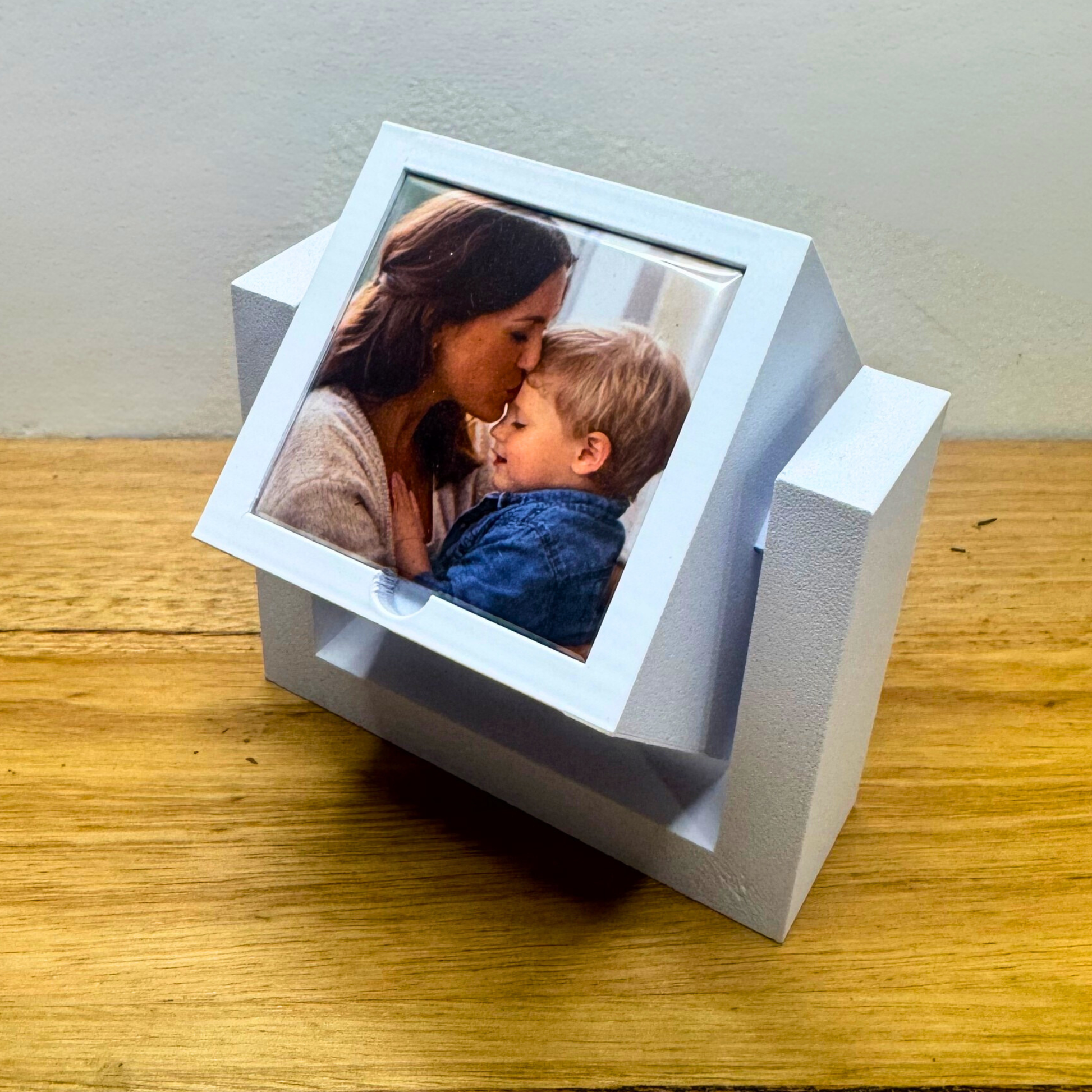Rotating photo magnet display cube holding four custom photo magnets